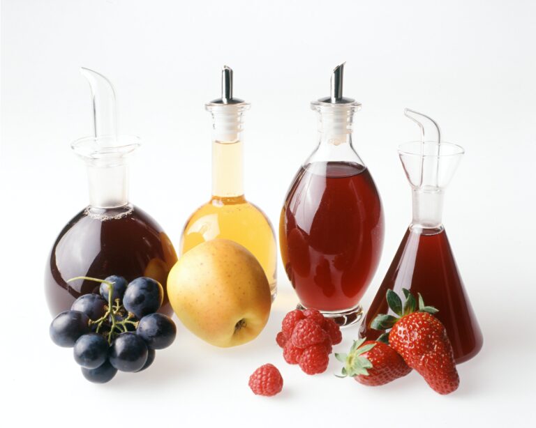 An assortment of fruit vinegars with fresh fruit