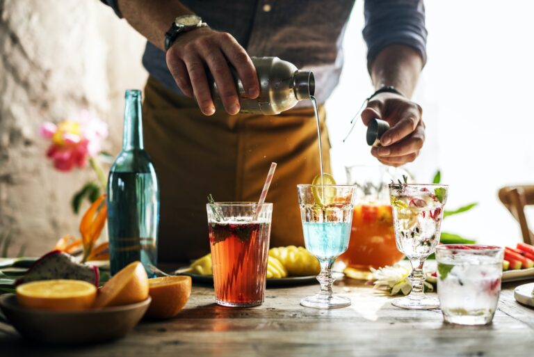 Bartender mixing colorful cocktails