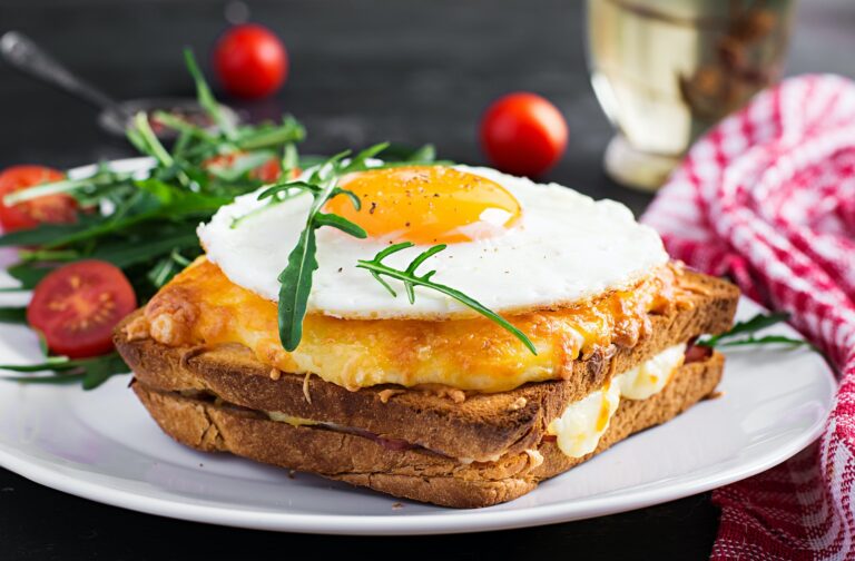 Breakfast. French cuisine. Croque madame sandwich close up on th