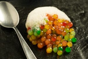 colorful molecular food with foam and spoon