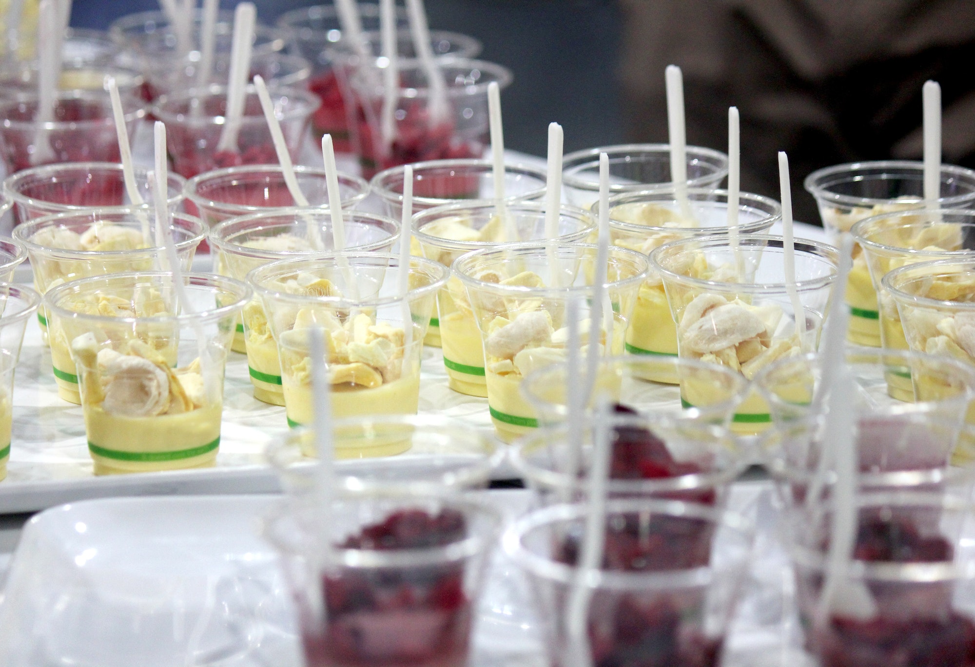 Panna cotta dessert samples on display for taste testing at a food expo