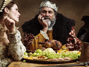 Royal life can be tedious...A bored queen sitting alongside her husband at a banquet.