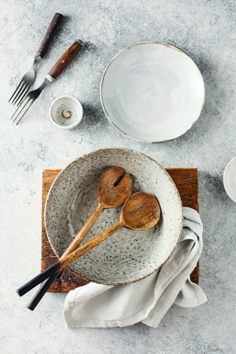 Set of dishes and kitchen utensils on a gray background, top view