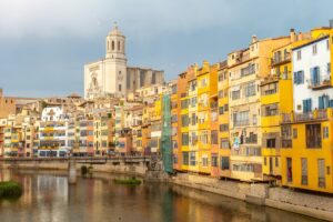 Girona medieval city, basilica and the cathedral next to the colored houses