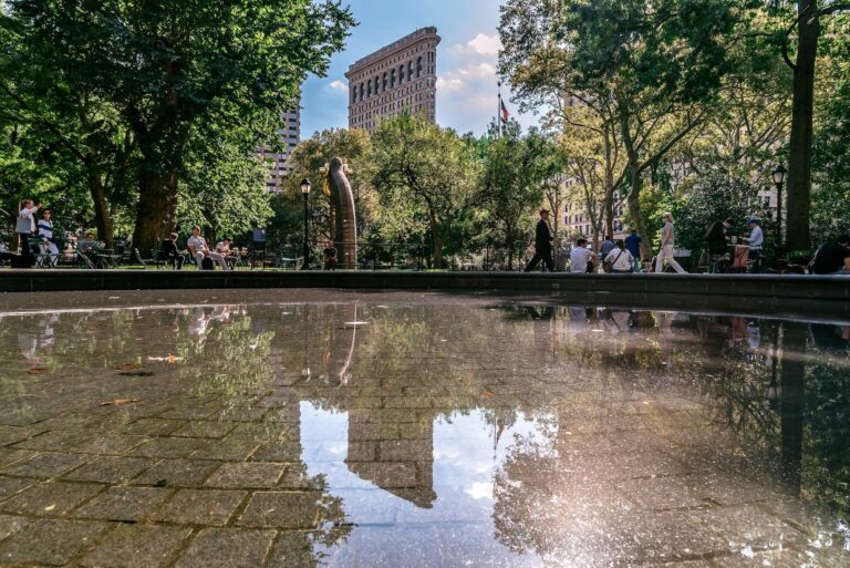 Reflection view of Flatiron Building from Madison Square Park.